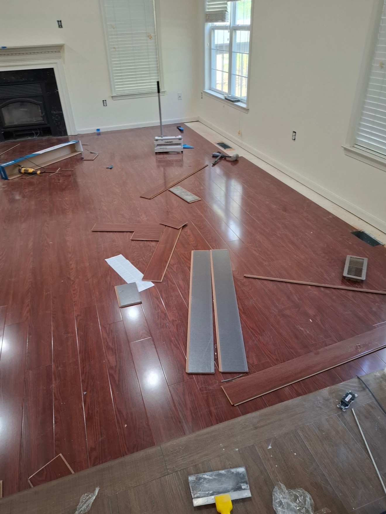 Francisco installing hardwood flooring in a living room