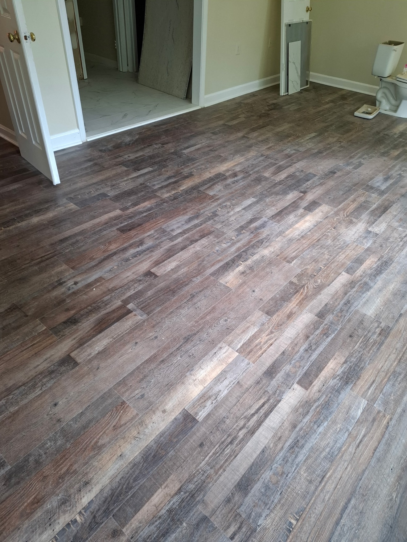 Francisco's finished wide-plank vinyl floor across a room
