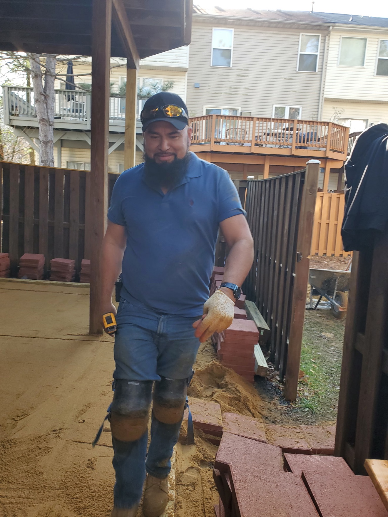 Francisco at work laying a paver patio