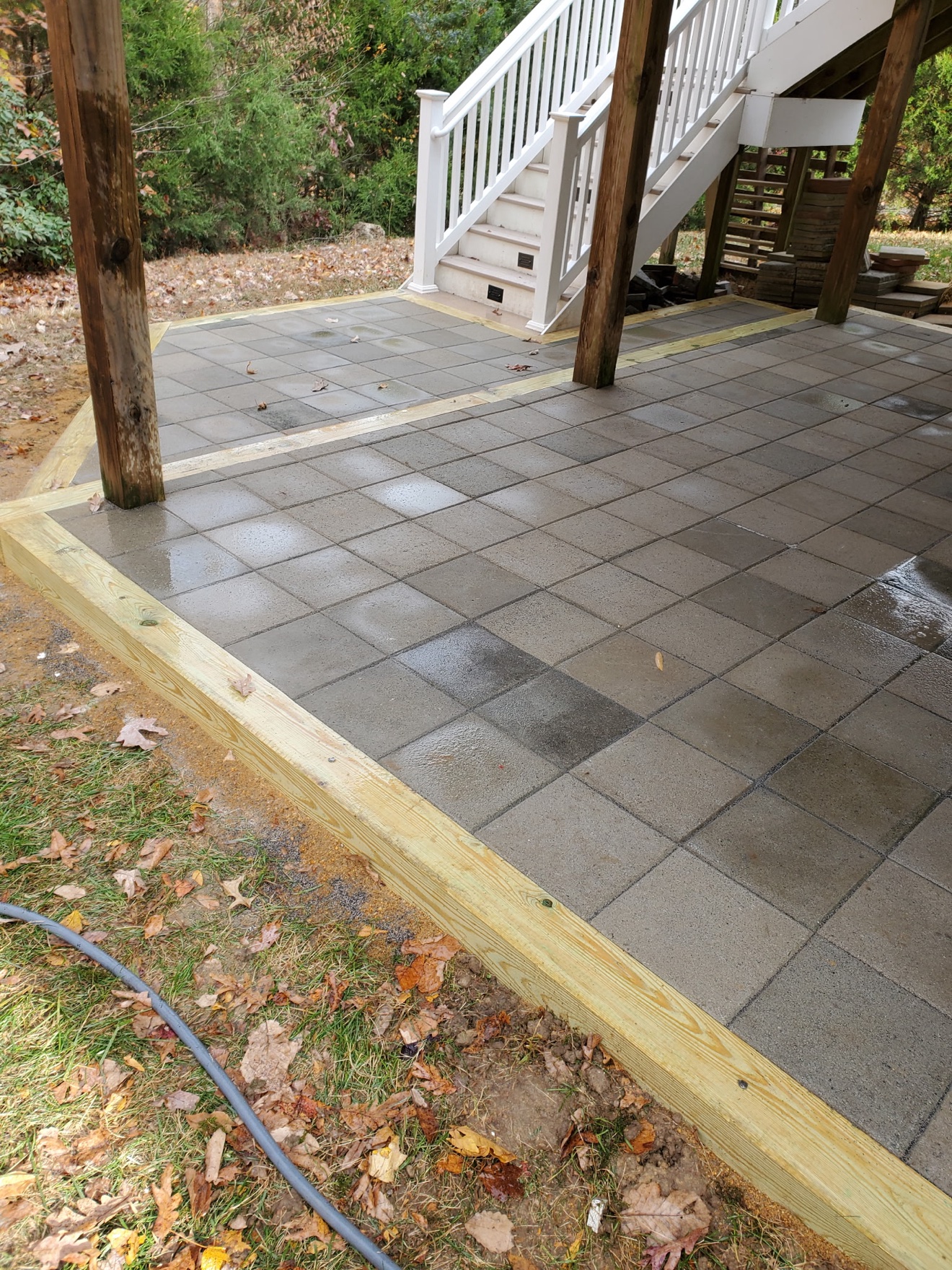 Francisco's finished gray paver patio beneath a deck