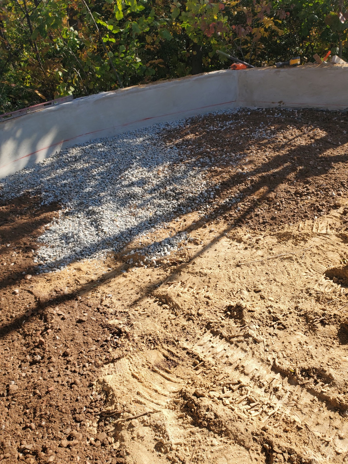 Gravel base going in inside formed walls
