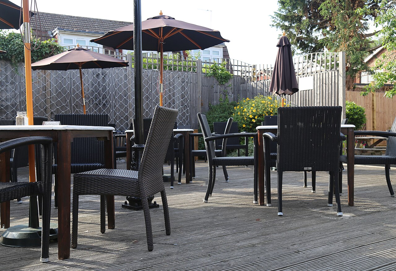 Finished wooden deck with furniture and umbrellas